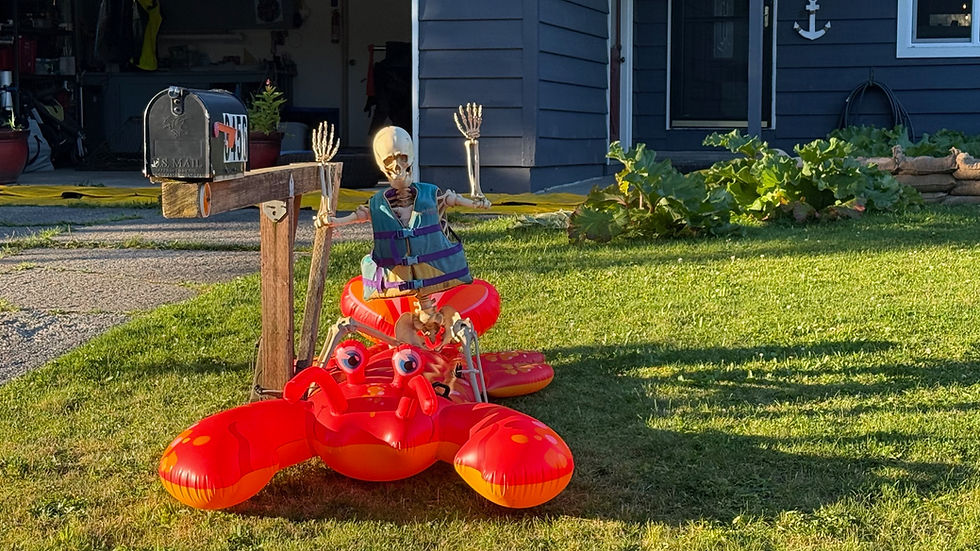 A skeleton wears a life jacket atop an inflatable lobster outside a house on Meander Way on Tuesday, Aug. 12, 2025. (Photo by Ben Ruel)