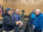 Don Beitzel, left, a former U.S. Coast Guard quartermaster, and retired Capt. John Alan "Al" Doty, right, discuss their service during different eras aboard the Coast Guard’s original Storis light icebreaker following the screening of a documentary about the ship at the Alaska State Library, Archives and Museum on Saturday, Aug. 10, 2025. Damon Stuebner, center, an archivist at the state library who produced the film, hosted the screening a day before a new Storis icebreaker was commissioned. (Mark Sabbatini / Juneau Independent)