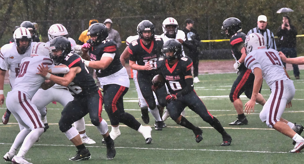 Juneau-Douglas High School: Yadaa.at Kalé senior wide receiver Noah Ault (0) follows junior Jaxin Jim (26) and senior Ricky Tupou (77) through the Dimond defense during the Crimson Bears' 15-14 win over the Lynx on Saturday, Sept. 20, 2025, at Adair-Kennedy Memorial Field. (Klas Stolpe / Juneau Independent)