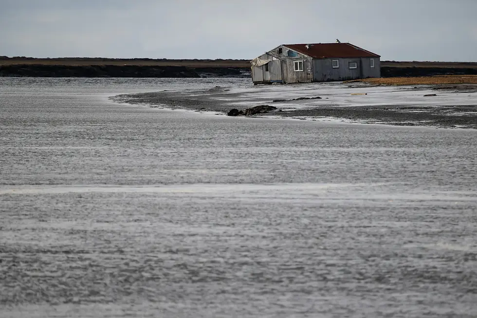 A home came to rest on a riverbank opposite Kipnuk during Halong. (Marc Lester / Anchorage Daily News)