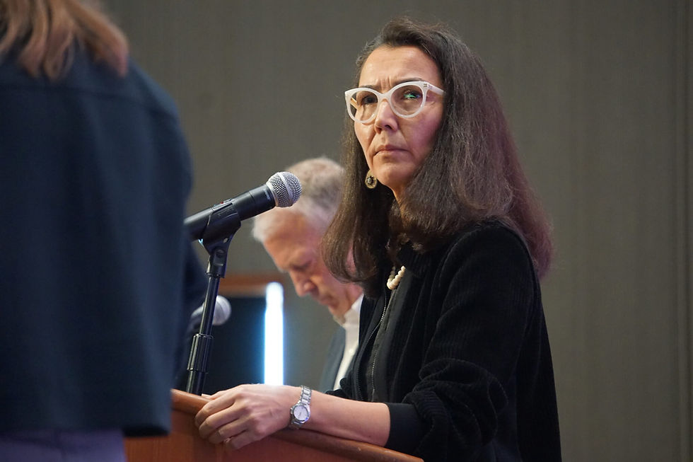 Mary Peltola listens to a question posed by moderator Michelle Egan at a candidate forum held by the Alaska Oii and Gas Association on Aug. 27, 2026. Next to Peltola is i Sen. Dan Sullivan. Peltola, a Democrat and former U.S. House member, is challenging Sullivan. (Yereth Rosen/Alaska Beacon)