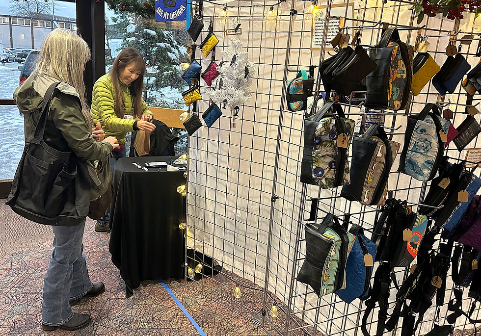 Deborah Winkelman bags a purchase for a customer at the Juneau Public Market at Centennial Hall on Sunday, Nov. 30, 2025. (Mark Sabbatini / Juneau Independent)