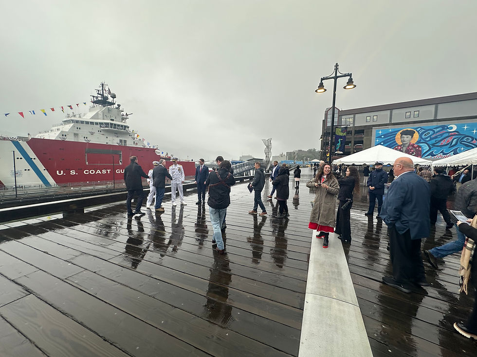 U.S. Coast Guard officers, political leaders and other guests chat following a commissioning ceremony for the Storis icebreaker, seen in the background, on Sunday, Aug. 10, 2025, at Elizabeth Peratrovich Plaza. (Mark Sabbatini / Juneau Independent)