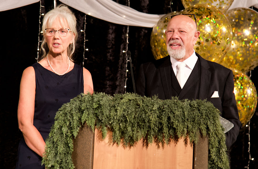 Kenny Solomon-Gross and Dorain Gross, co-owners of Gross-Alaska Theatres, accept the Business of Distinction award from the Greater Juneau Chamber of Commerce during its annual gala at Centennial Hall on Saturday, Oct. 11, 2026. (Mark Sabbatini / Juneau Independent)