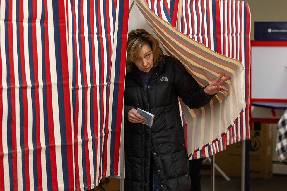 A voter leaves the voting booth at a polling location in Northumberland, N.H., last year. Republican New Hampshire Secretary of State David Scanlan has refused to provide the state’s voter data to the U.S. Department of Justice. (Scott Eisen/Getty Images)