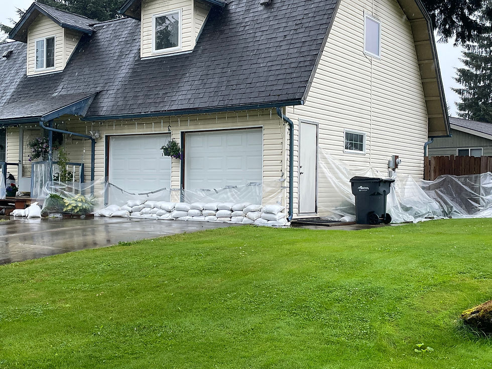 Sandbags and plastic sheeting to protect a home near the Mendenhall River are in place on Monday, Aug. 11, 2025. (Laurie Craig / Juneau Independent)