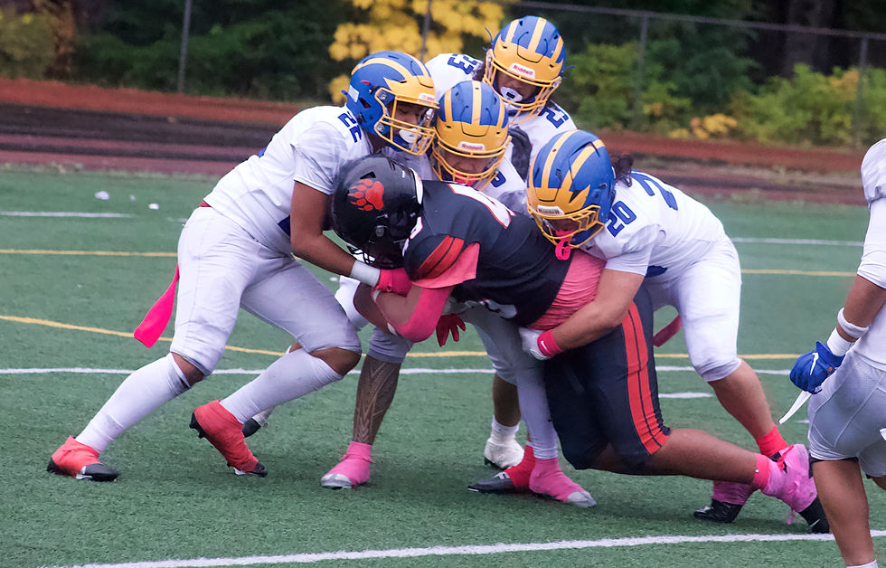 Helaman Aitaoto-Tele'a, a junior lineman for Juneau-Douglas High School: Yadaa.at Kalé, is tackled by four Bartlett High School players as he tries to run a catch into the end zone during the Crimson Bears’ 33-28 victory at Adair-Kennedy Memorial Park on Saturday, Oct. 3, 2026. (Mark Sabbatini / Juneau Independent)