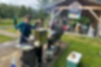 KTOO Public Media employees host a community barbecue at Riverside Rotary Park on Thursday, July 17, 2025, for people preparing for a possible glacial lake outburst flood. (Mark Sabbatini / Juneau Independent)
