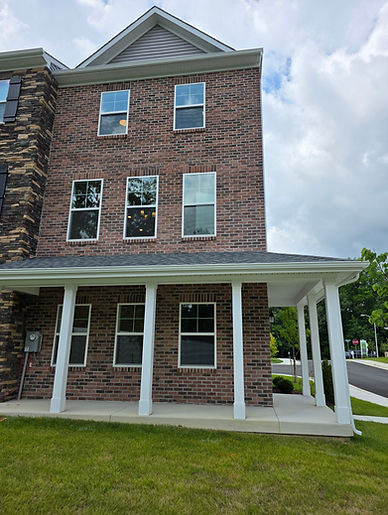 Kennedy home with a full wrap front porch and full brick front.