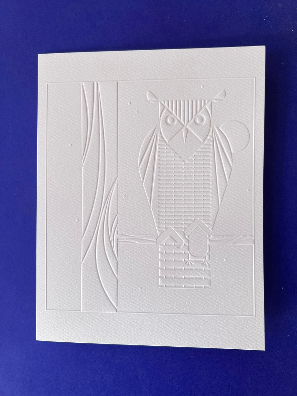 Thumbnail: an embossed image of an owl