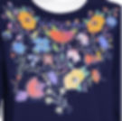 front image of dark blue shirt featuring colorful flowers and birds