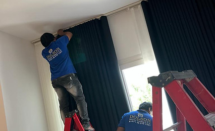 Two men on ladders, diligently working on a window, ensuring its proper maintenance and repair.