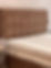A simple bed with a mattress and box spring, set in a cozy room that emphasizes comfort and tranquility.