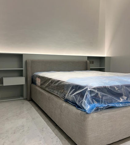 A bed with a protective plastic cover to prevent stains and spills.