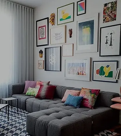 A cozy living room with a comfortable couch, a stylish coffee table, and beautiful pictures adorning the wall.
