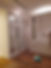 A man capturing an image of a room adorned with stylish white cabinets, showcasing contemporary home decor.