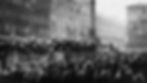 Crowd watches soldiers in helmets on a truck in the city square of Munich, surrounded by tall buildings. The place where Hitler delivered his speech, Beer Hall Putsch (Munich Putsch)