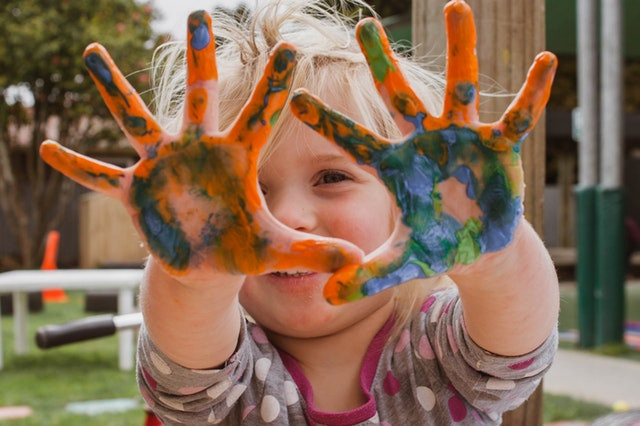 kid with painted hands