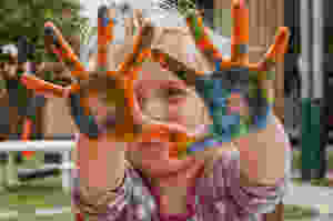 kid with painted hands