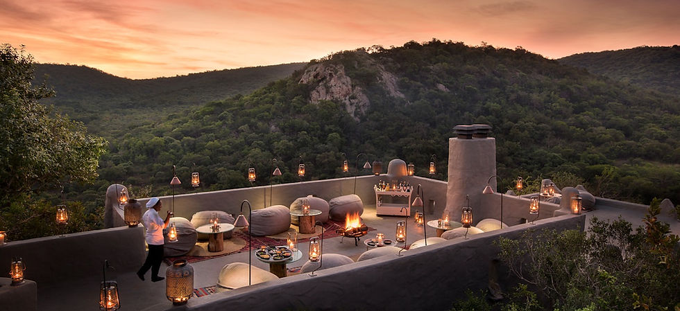 Lantern-lit terrace at sunset at andBeyond Phinda Rock Lodge overlooking the Zululand hills, Phinda Private Game Reserve