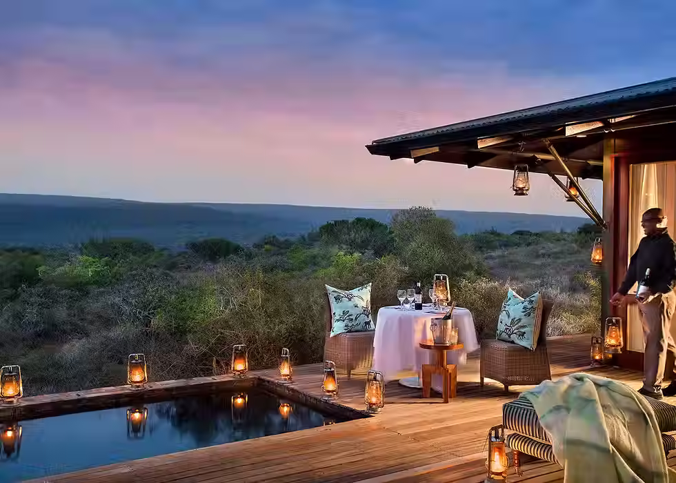 Lantern-lit deck, plunge pool and outdoor dining area at Kwandwe Ecca Lodge in the Eastern Cape.