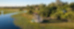 Aerial view of Jao Camp beside Okavango Delta floodplains and waterways, showing its water-focused luxury safari lodge setting.