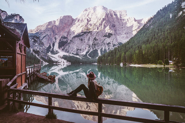 Adventure lifestyle Girl with backpack at Pragser Wildsee