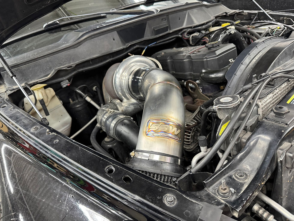 Close-up view of a turbocharger installed in a car engine bay