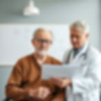 a doctor studying a checklist with a 65 years old male patient.jpg