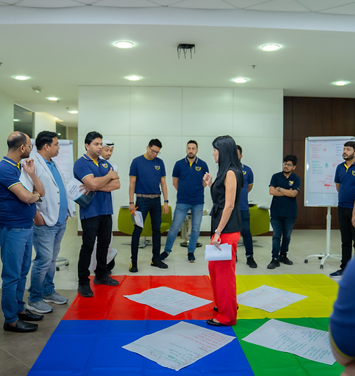 Team using gamestorming mats during Forward Training workshop to foster innovation and collaborative brainstorming.