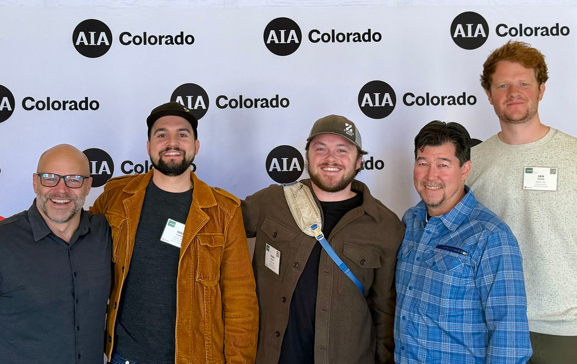 Z Group team members pose at the AIA Colorado Conference, standing in front of the event backdrop. The group smiles proudly, representing the firm’s continued engagement in architectural leadership and statewide industry dialogue.