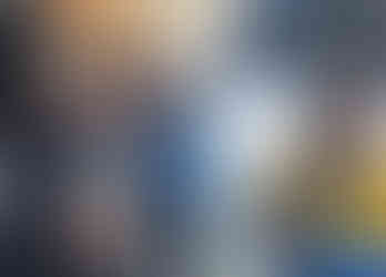 Z Group team member enjoying spring ski day in Snowmass with mountain views behind Aspen architecture team.