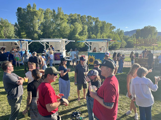 Attendees mingle near local food and beverage vendors along the Roaring Fork River during the Basalt Summer Concert Series opening event.