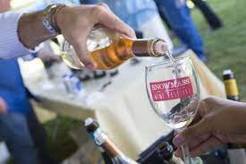 Wine being poured at Snowmass Wine Festival outdoor tasting event