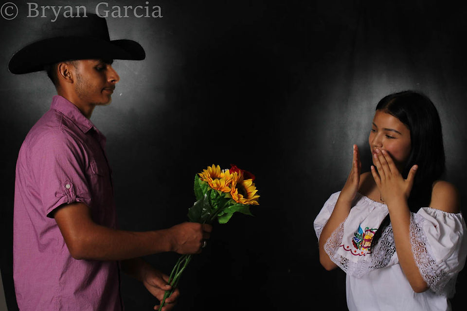 He's handing her flowers 