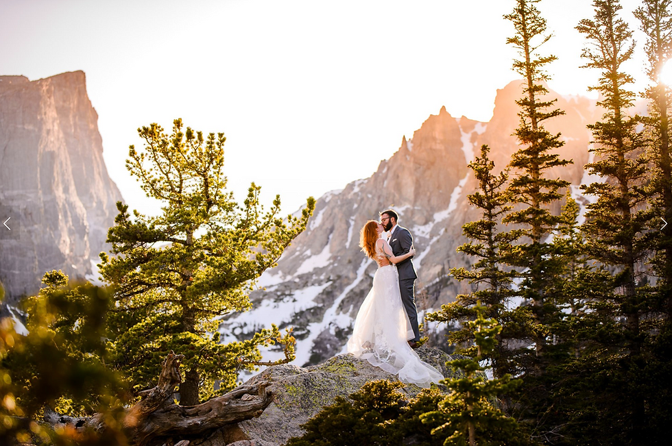 A couple holdomg each other with the astonishing views of the Rocky Mountain National Park in Colorado as their backdrop.
