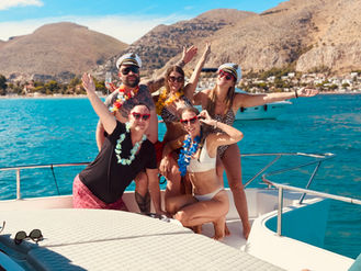 Guests toasting drinks on board during sunset boat experience