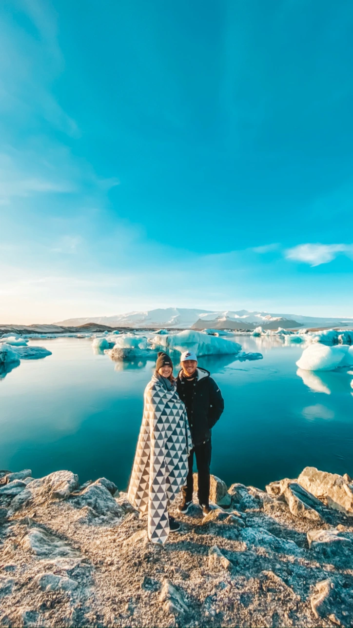 Husband and wife in front of glacier pool