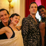 Four people smile at the camera.