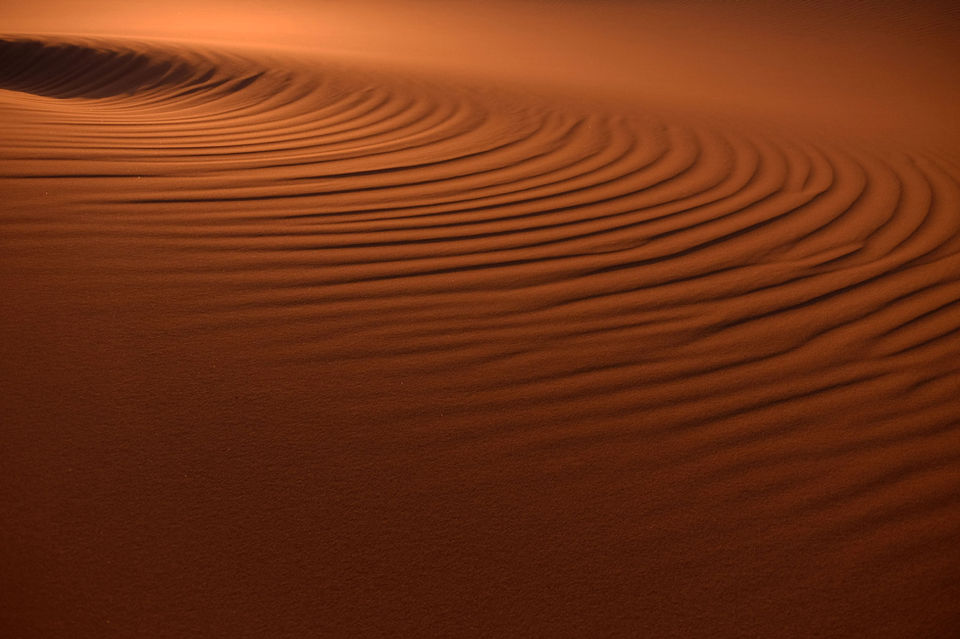 Abstract photo of circular sand patterns in the golden Karin Desert, Iran — artistic aerial photography of desert landscapes and natural textures