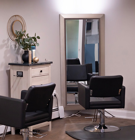 Modern salon stations at Adrift Spa with styling chairs, mirrors, and hair tools ready for clients.