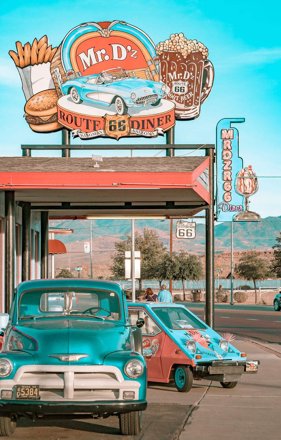Vintage cars line up outside Mr. D'z Route 66 Diner in Kingman, Arizona, where the road's classic American character is still very much alive. Photo by Heidi Kaden on Unsplash