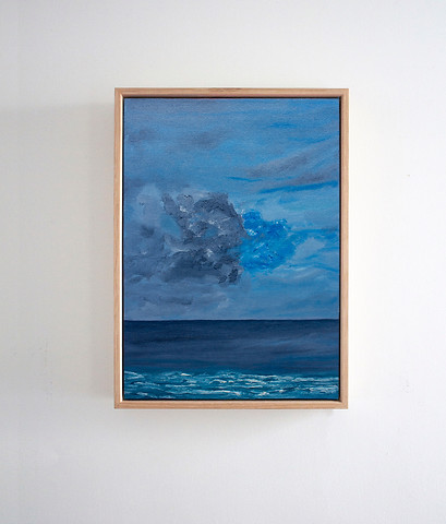 Framed ocean painting on wall