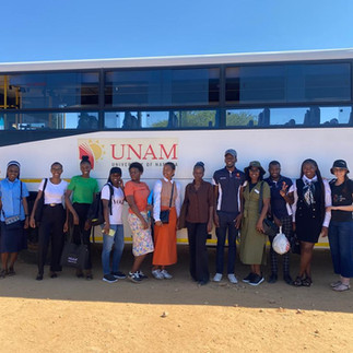 UNAM students standing in front of a bus