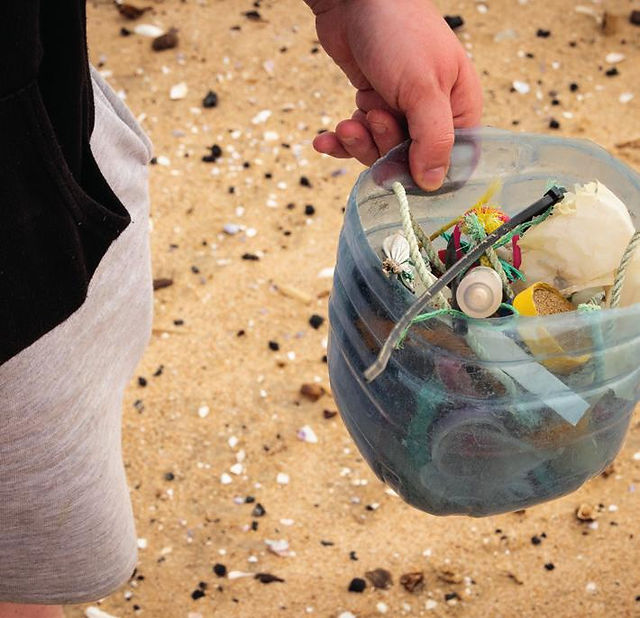 Bucket with pieces of trash