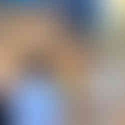 Woman smiling with hydroponic system in the background