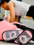 Pink boxing gloves at martial arts class