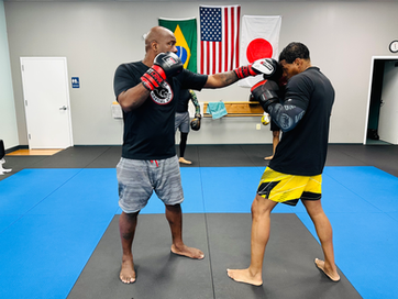 Instructor and student boxing during martial arts classes