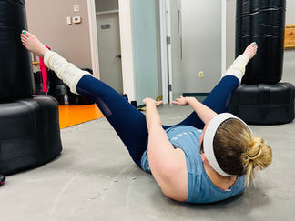 Woman doing leg raises during fitness class