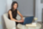 sarah, trauma informed coach on laptop in office